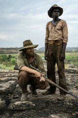 Simon Baker as Travis and Jacob Junior Nayinggul as the adult Gutjuk.