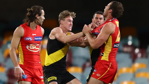 Richmond's Tom Lynch scuffles with Jarrod Witts of the Suns.