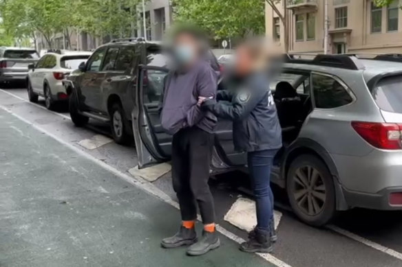 Police escorting one of the alleged offenders accused of keeping a slave at their Point Cook home.