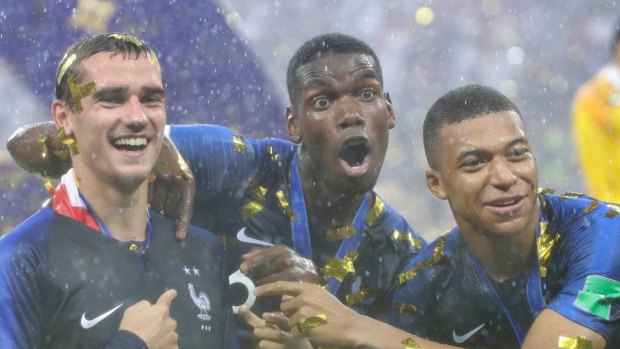 France's Antoine Griezmann celebrates with Paul Pogba and Kylian Mbappe after the final match between France and Croatia at the 2018 soccer World Cup. France won the final 4-2.