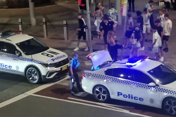 Police arrive at the scene to disperse the crowd outside Manly Wharf.