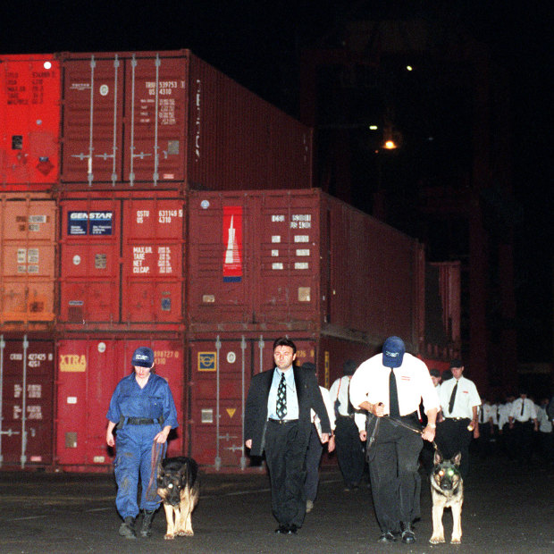 In an iconic image of the dispute, photographer Dean Sewell captured security guards with dogs turfing workers out of Patrick's Sydney port botany wharf.