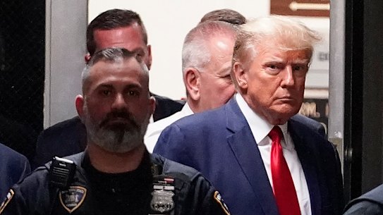 Donald Trump leaves the District Attorney’s office before making the short walk to the court.