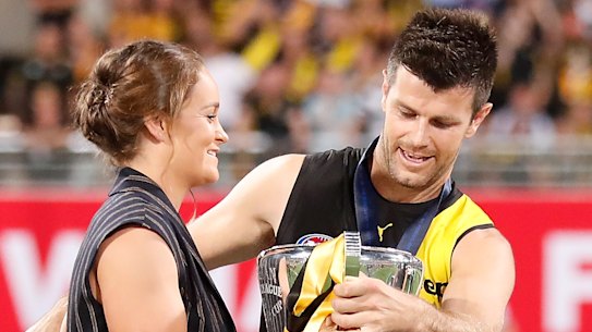Ashleigh Barty presents the 2020 AFL premiership cup to Trent Cotchin in Brisbane.
