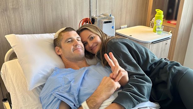 Lions legend Jonathan Brown recovers from brain tumour surgery in hospital, pictured with his wife Kylie.
