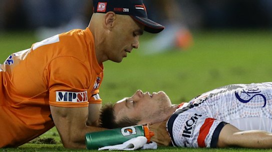 Down and out: Luke Keary receives attention before leaving the field. 