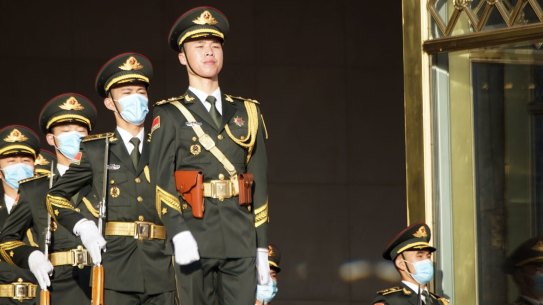 Members of the People’s Liberation Army (PLA) march outside the Great Hall of the People in Beijing on Wednesday.