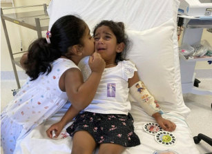 Tharnicaa and her sister Kopika in hospital on Christmas Island in 2021.