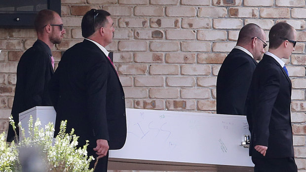 Peter Beilby (second from right), father of Larissa, and her brother Nathan (left) assist pallbearers with the casket of the slain Brisbane teenager at Lakeview Chapel, Albany Creek Memorial Park.