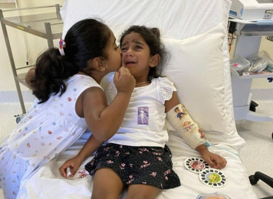 Tharnicaa and her sister Kopika in hospital on Christmas Island in 2021.