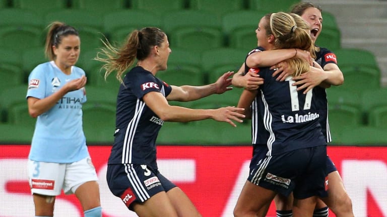 Melbourne Victory celebrate their first-half goal in a historic W-League derby against Melbourne City. 