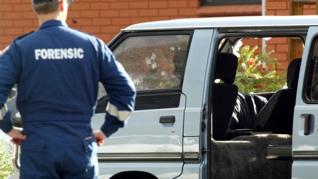 Police examine the van in which Jason Moran and Pasquale Barbaro were murdered.