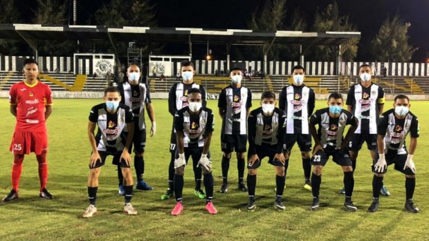Diriangen FC players wear masks before a game in Nicaragua.
