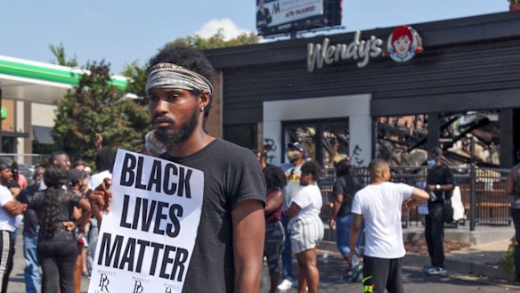 Protesters outside the Wendy's restaurant on Sunday, June 14, local time.