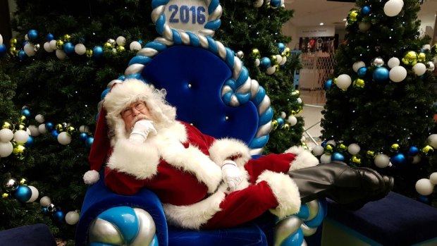 Canberra Santa Claus Tony Moore having a little rest in his lunchbreak at South.Point shopping centre.