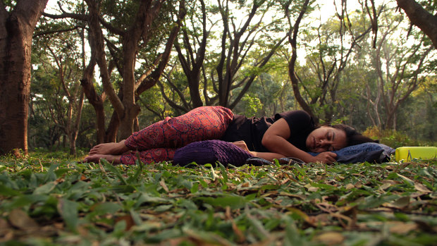 A woman "sleeping" in a park in Bangalore, in a protest aimed at reclaiming public spaces for women.