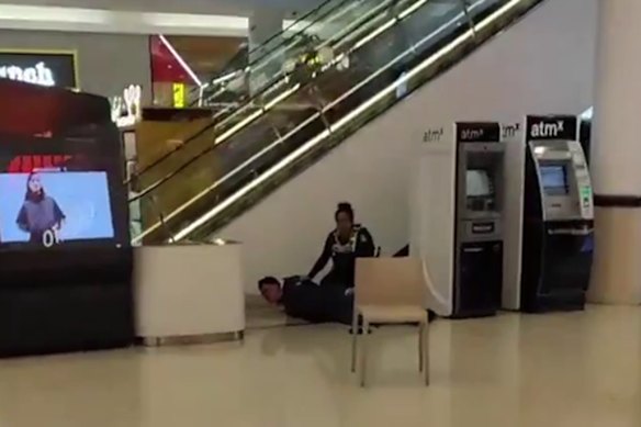 A photo taken by a witness at Northland shows a police officer wrestling a person to the ground.