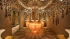 The toilets at Bacchanalia in London feature marble-tiled floors spread out like flower petals while painted vines cascade from the ceiling.