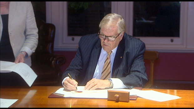 WA Governor Kim Beazley signing the anti-Clive Palmer legislation into law.