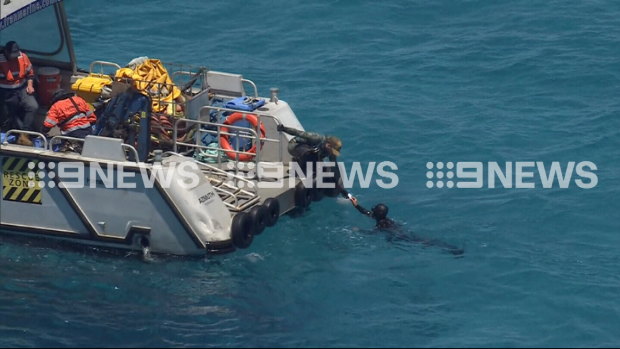 Divers secured straps around the plane.