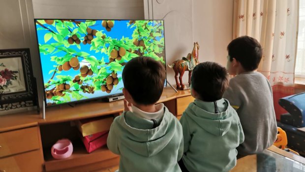 Gloria Zeng's children watch a video while under lockdown in Wuhan.