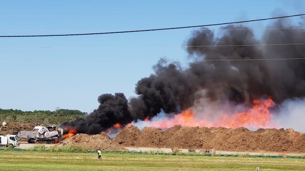 A mulch machine is on fire at a Caboolture tip, north of Brisbane.