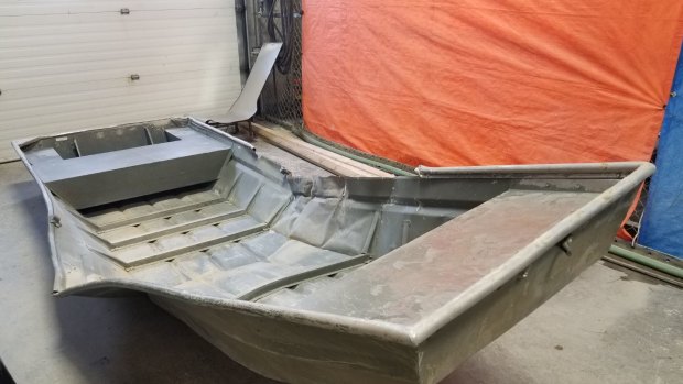 Police officers searching from a helicopter, located a damaged aluminium boat on the shore of the Nelson River in Manitoba.