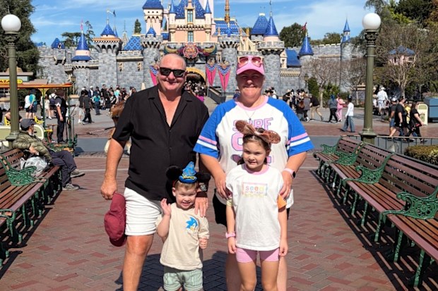 Male breast cancer sufferer Phil Smith with wife Donna and two of his grandchildren.