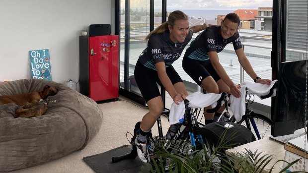Cyclists Natasha (right) and Holly Cogle ride an indoor Zwift session at their Little Bay home.
