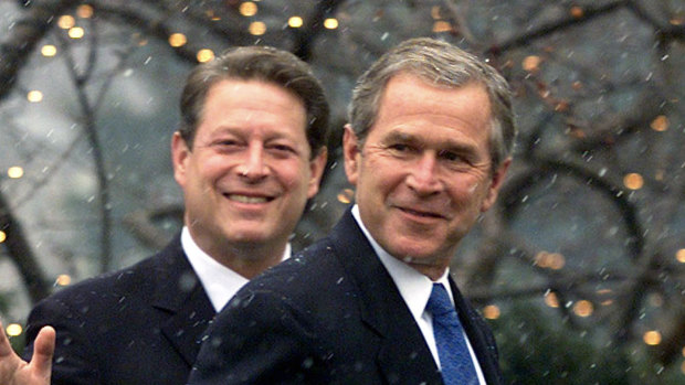 Vice President Al Gore, left, waves as he escorts President-elect George W.  Bush into his residence after Bush arrived for a meeting December 19, 2000.