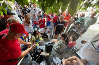 Djokovic supporters listen to the decision outside the Federal Court. 