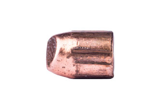 A single bullet marked with striae after being discharged from a handgun.
