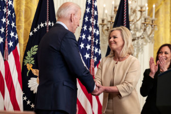 Carlson and U.S. President Joe Biden shake hands during an event for the signing of the “Ending Forced Arbitration of Sexual Assault and Sexual Harassment Act of 2021” into law.