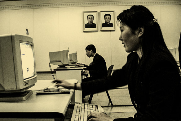 Students engage in a simulated internet chat in the Grand People’s Study House in Pyongyang, under portraits of Kim Il-Sung and his son, KIm Jong-il.