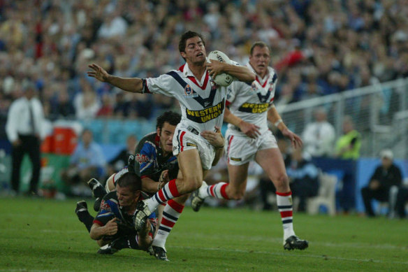Grand final victory: Anthony Minichiello is tackled during the 2002 premiership win over the Warriors.