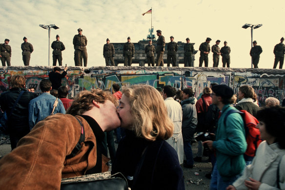 A young couple celebrate the opening of the Berlin Wall in 1989.