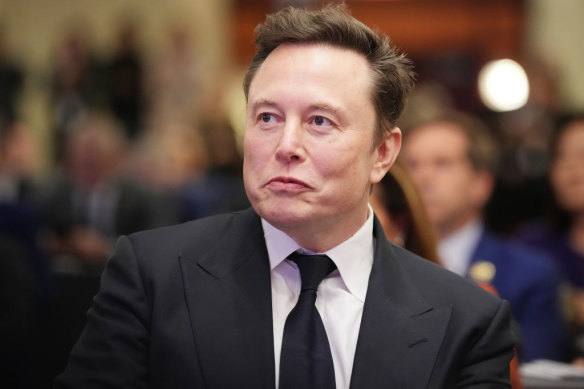 Elon Musk listens as president-elect Donald Trump speaks.