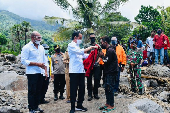 Indonesia president Joko Widodo inspects damage at Amakaka village in the province of East Nusa Tenggara on Friday. 