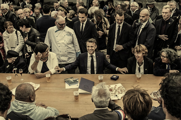 Emmanuel Macron (centre) on the campaign trail, with residents of Ile de Sein in Brittany on June 18.