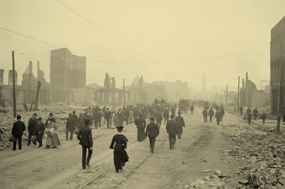 People walk among the ruins of San Francisco after an earthquake in 1906.   

