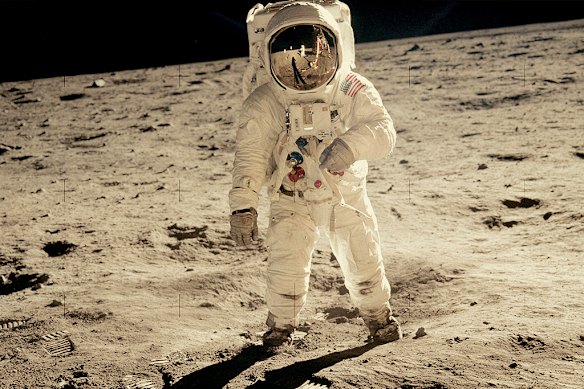 US astronaut Buzz Aldrin on the Moon in 1969. Fellow astronaut Neil Armstrong and the lunar module are reflected in his visor, which has a foil coating with gold in it to deflect solar radiation. 