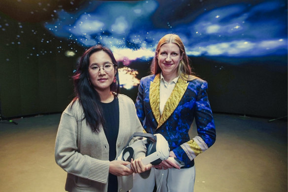 Zinia Chan with researcher Solange Glasser in front of a representation of Chan’s synaesthesia. 