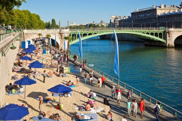 Parisiens enjoy “la plage” by the Seine in  summer.