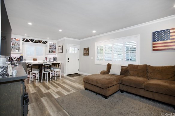 The living, dining and kitchen area leads to the laundry, before a ‘bonus room’ and then the bedrooms.