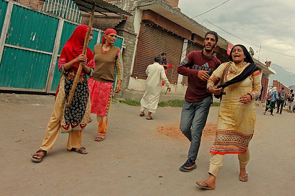 A Kashmiri woman weeps after her relative was injured during clashes over India’s change to the region’s status in 2019.