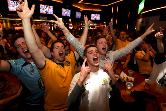 Soccer fans watch the Australia vs Holland World Cup match in the Sports Bar, at the Star in Pyrmont, Sydney.