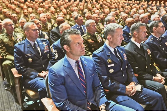 Hegseth with US military senior leadership listening to Donald Trump after Hegseth’s speech about standards in the military, at the Marine Corps base in Quantico, Virginia in September.   