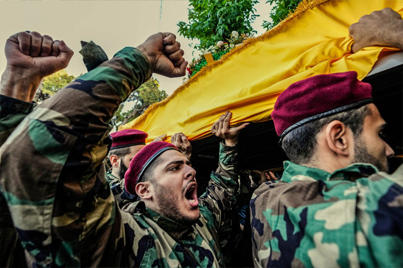 Hezbollah members carry the coffins of two commanders during a funeral procession in Beirut’s southern suburbs on September 25. 