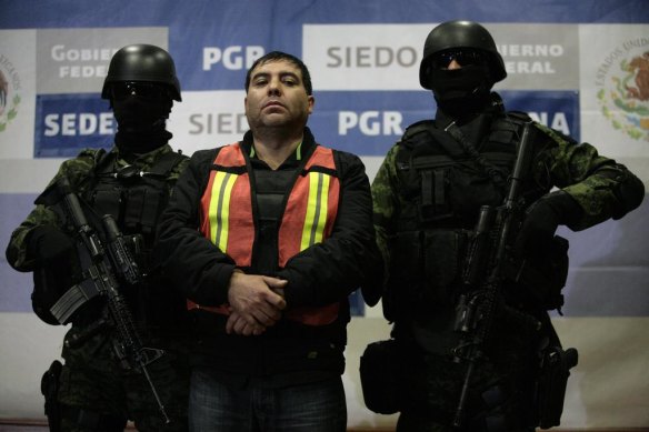 Suspected Sinaloa cartel member Felipe Cabrera Sarabia, also known as "El Inge", is paraded before journalists in Mexico City in 2011.  