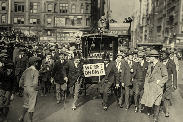 After Calvin Coolidge beat John Davis to the presidency in 1924, two men on the losing end of a bet pull the winner on a hansom cab down Fifth Avenue in New York.